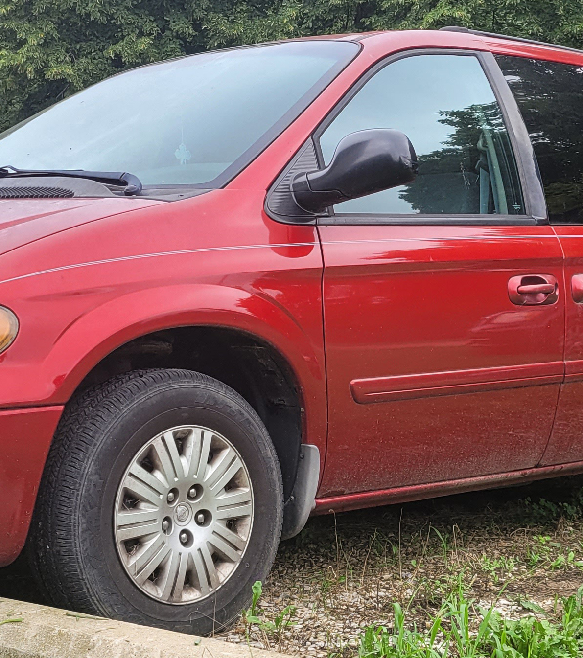 A 2006 red Chrysler Town and Country van.